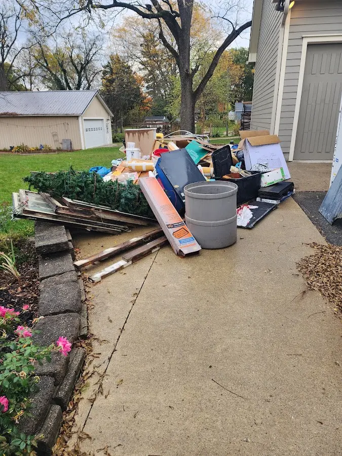 Dumpster being loaded with debris for Estate Cleanout Dumpster Rental in Millcreek